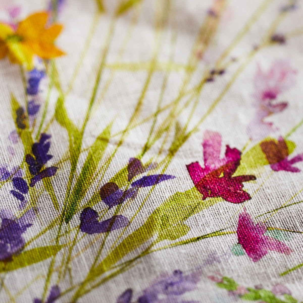 A close up of watercolor flowers on TTT Meadow Linen Tablecloth.
