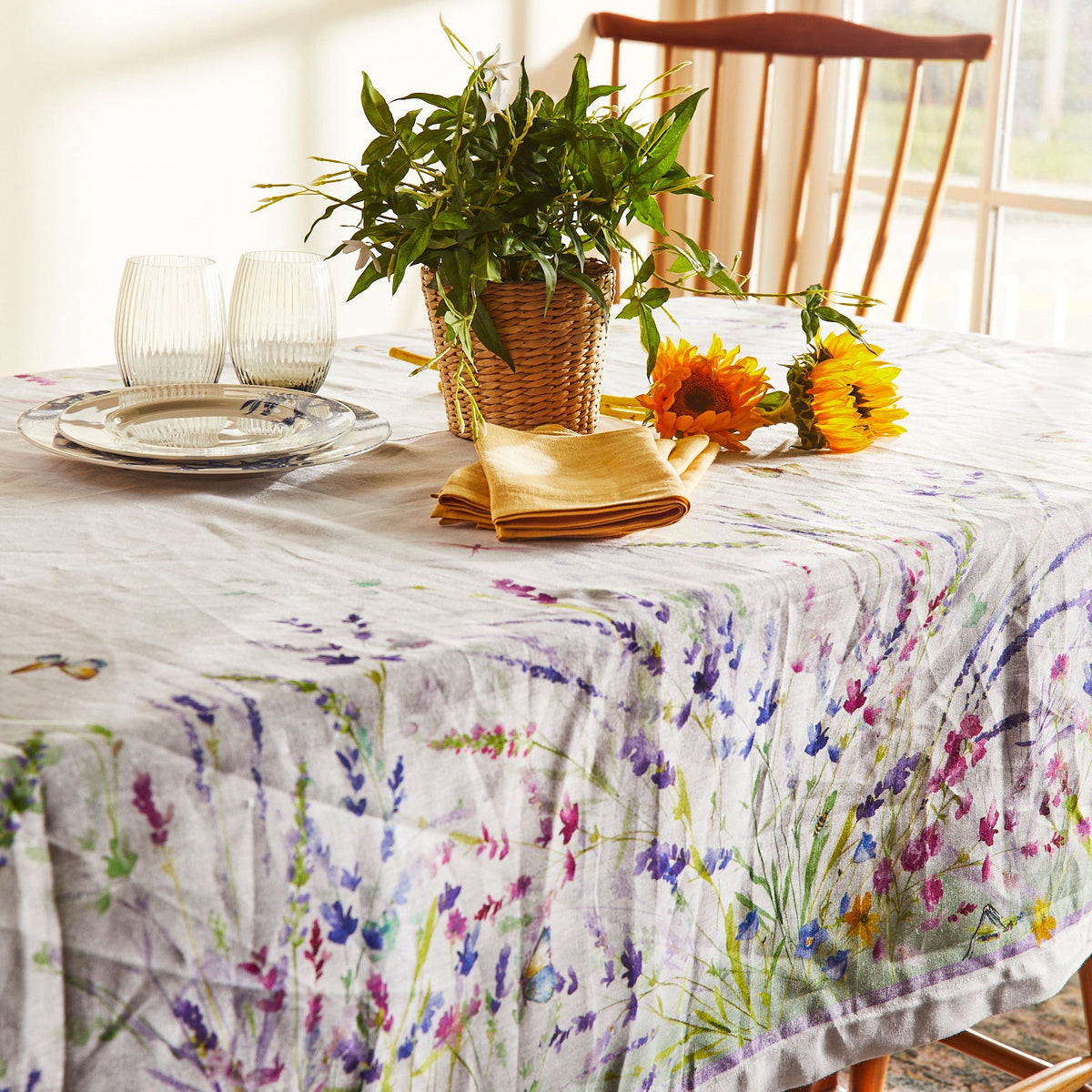 A Meadow Linen Tablecloth with wildflowers on it. Brand: TTT.