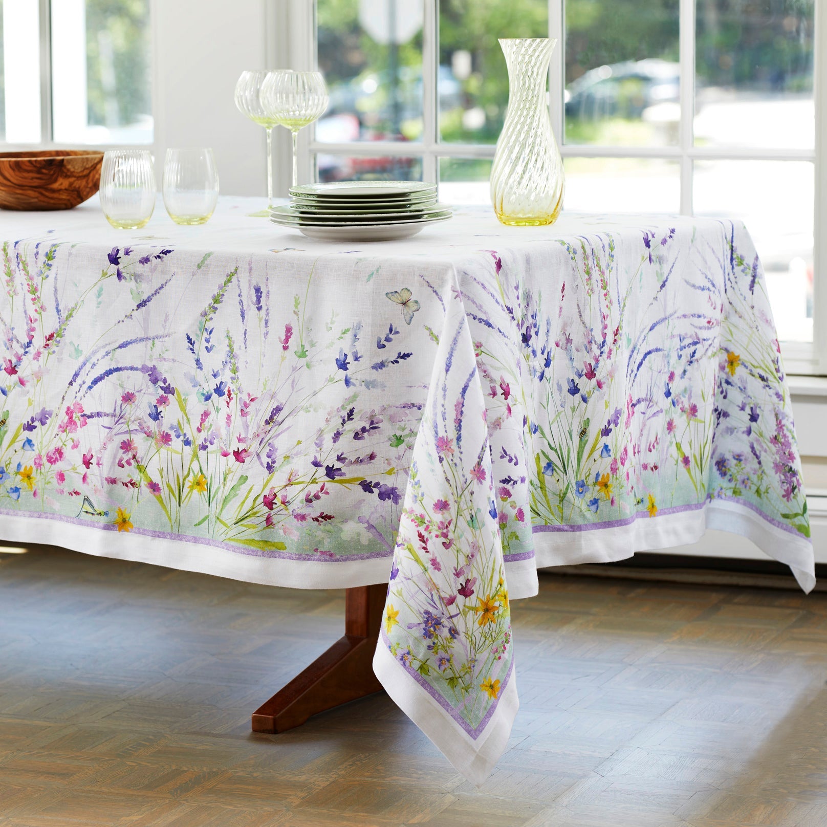 Meadow Tablecloth in 67" x 106" size features hand-painted floral watercolors in shades of blue, purple and green on Italian linen, from Caskata