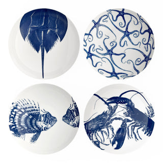 The Caskata Coastal Icons Entrée Bowls, Mixed Set of 4, features white bowls with blue marine life designs—horseshoe crab, brittle stars, lionfish, and lobster—bringing seaside charm to your table.