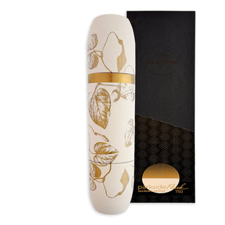 A white and gold leaf-patterned Caskata x High Camp Crema Morning Glory Fern Wine Flask stands upright next to a rectangular black box labeled with the Caskata brand, featuring durable stainless steel construction.