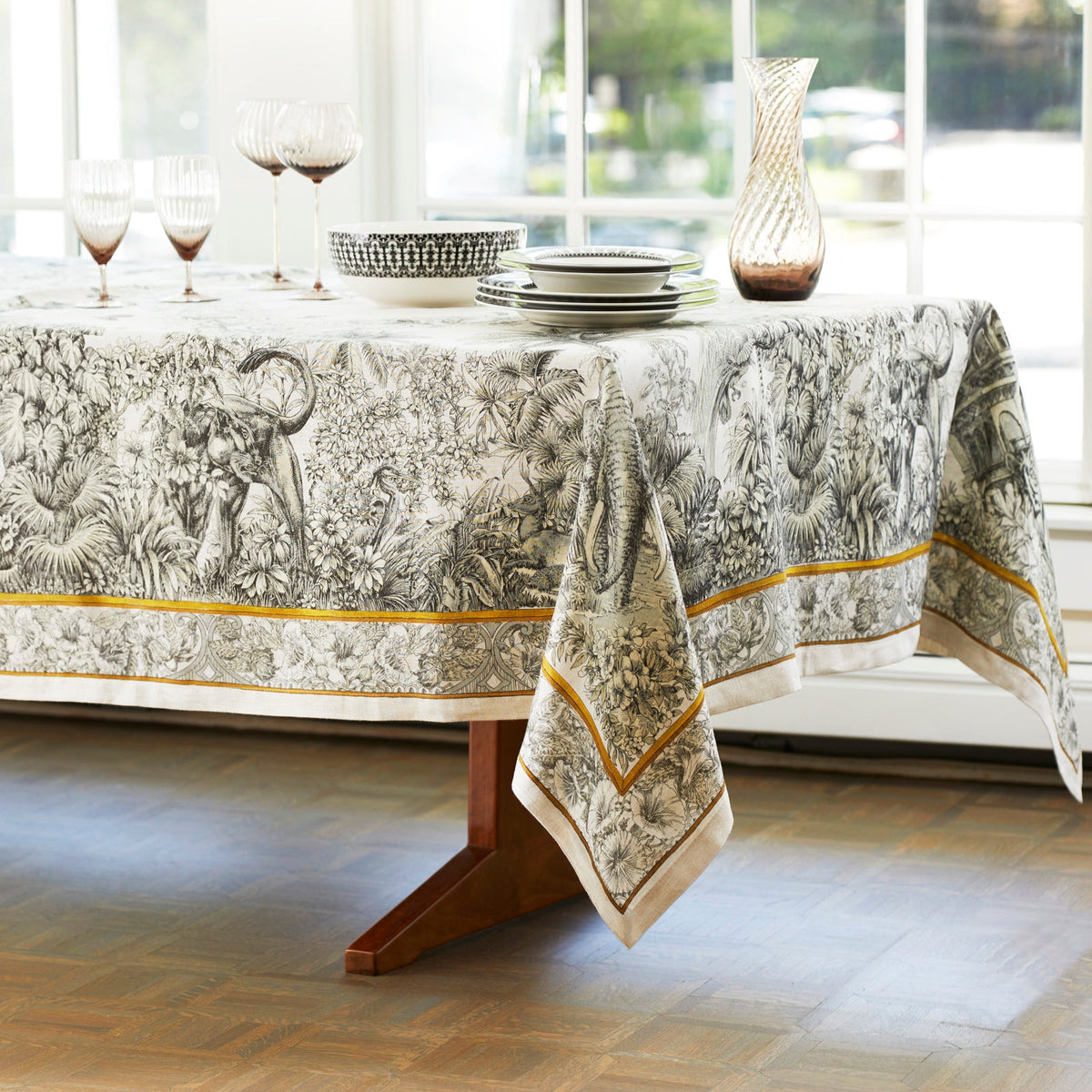 A Morocco Linen Tablecloth with a TTT design beautifully covers the table.