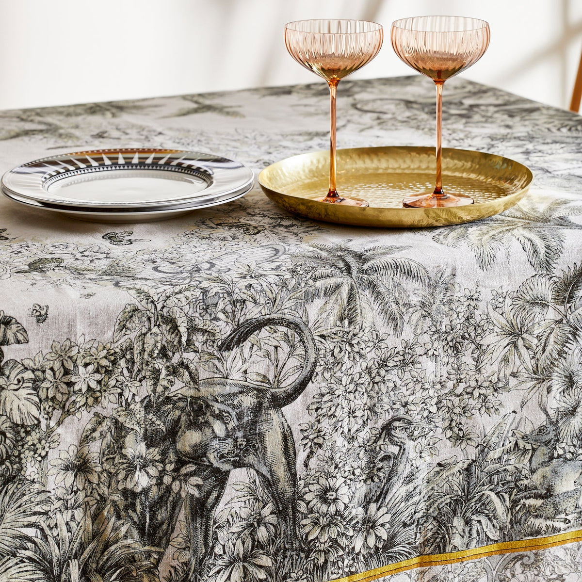 Panther Detail with Quinn Amber Coupe Glasses on Moroccan Linen Tablecloth in Black and White from Caskata