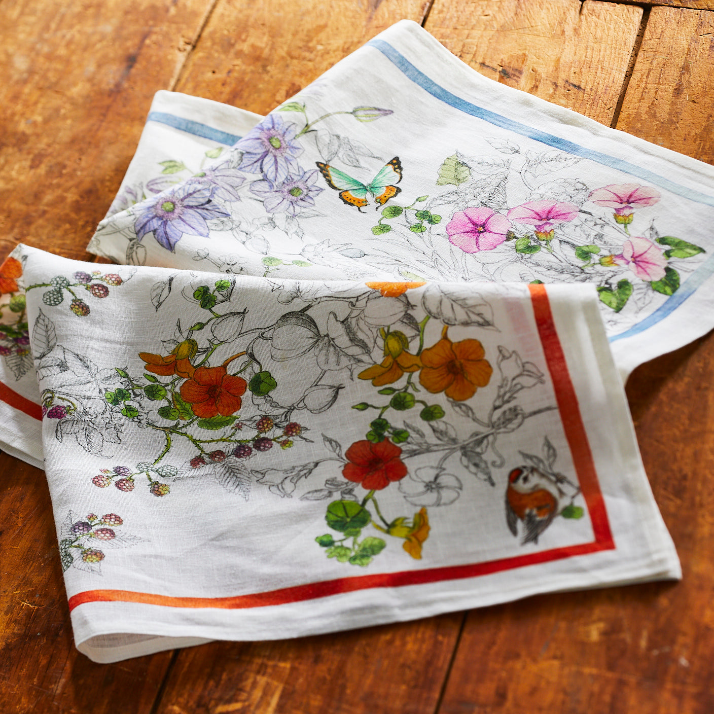 Nasturtiums playfully dance across this set of two, 100% linen kitchen towels from Caskata