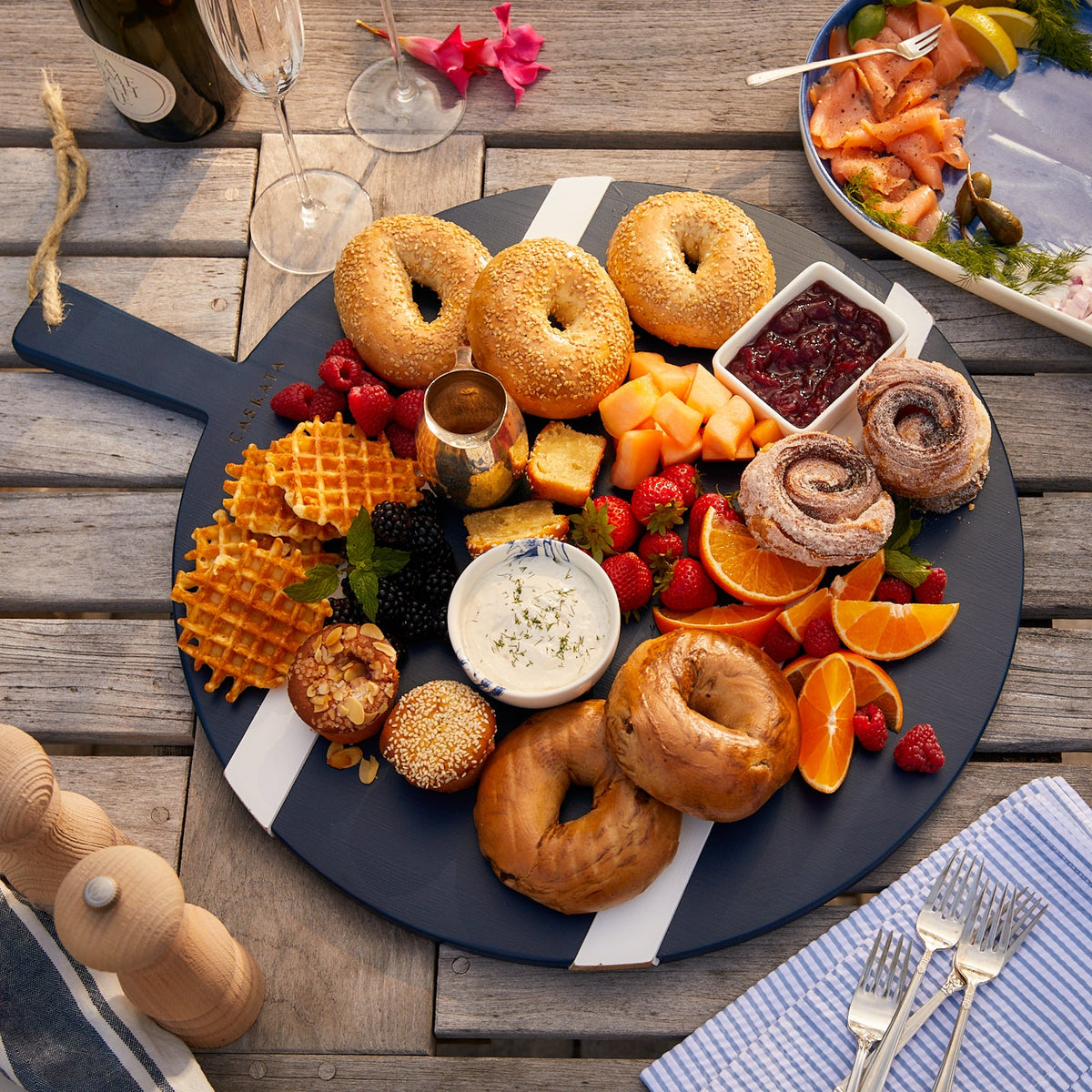 A versatile Navy and White Round Charcuterie Big Board with a variety of foods on an Etu Home for holiday entertaining.