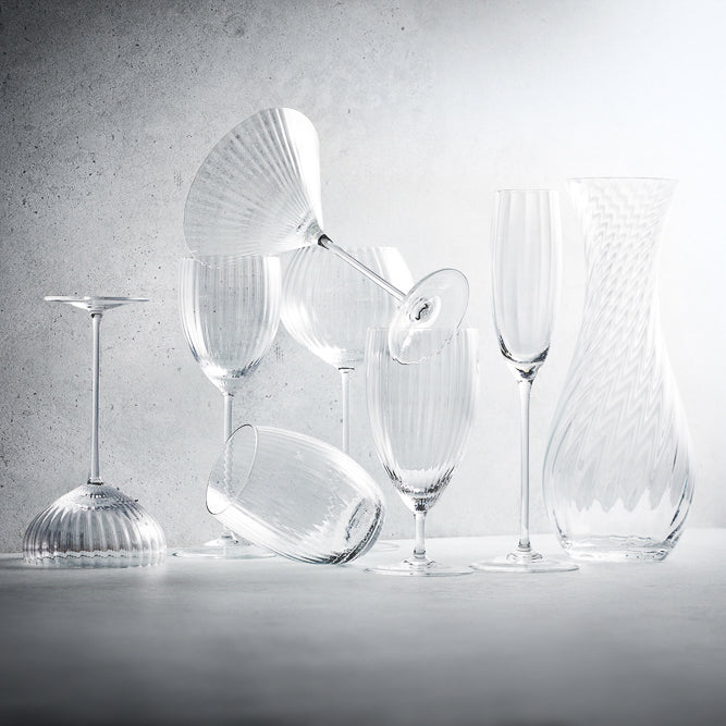A collection of various colors of the Quinn tumbler crystal glasses from Caskata.