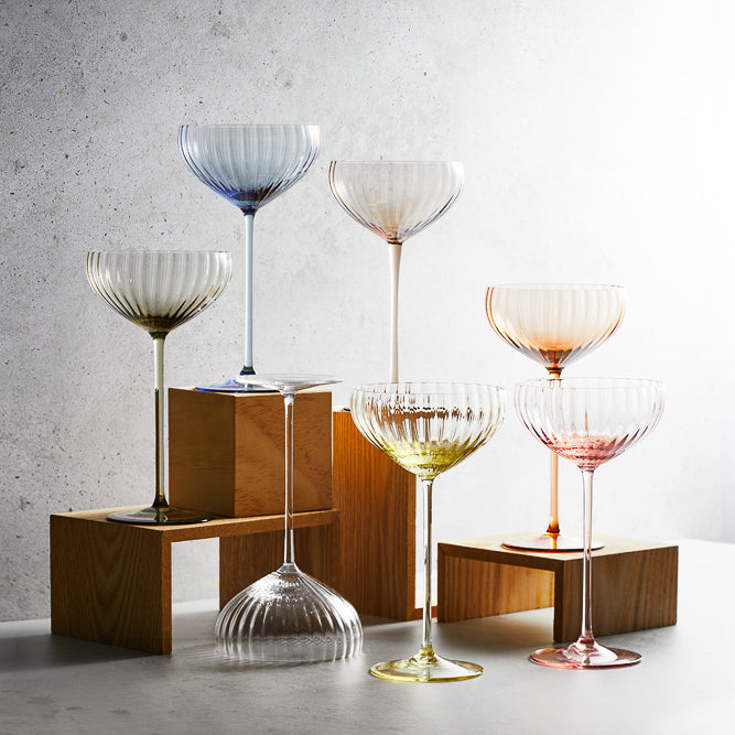 A collection of varied colors of the Quinn Coupe crystal glasses from Caskata.