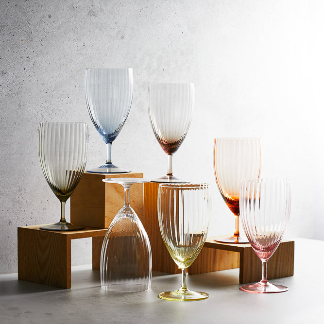 A collection of various colors of the Quinn Everyday crystal glasses from Caskata.