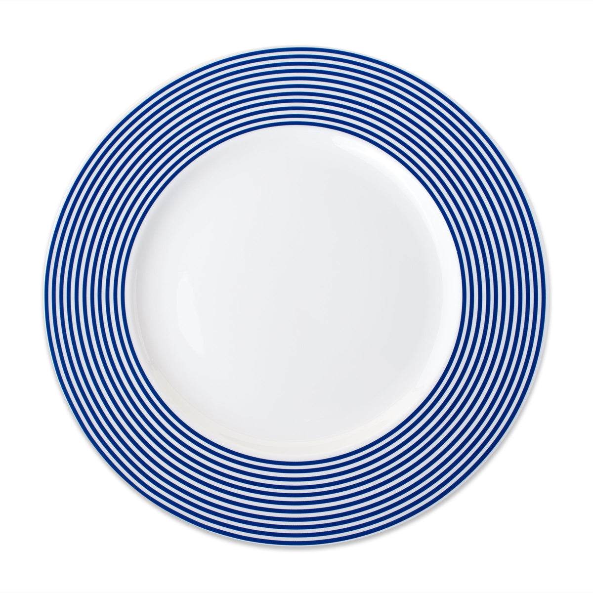 A Newport Racing Stripe Rimmed Dinner Plate from Caskata Artisanal Home, featuring blue and white stripes on a white background with porcelain layers.