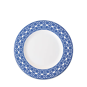 A Newport Garden Gate Rimmed Salad Plate with a blue geometric pattern around the rim, crafted from premium porcelain by Caskata Artisanal Home, perfect for adding a touch of elegance to any table setting.
