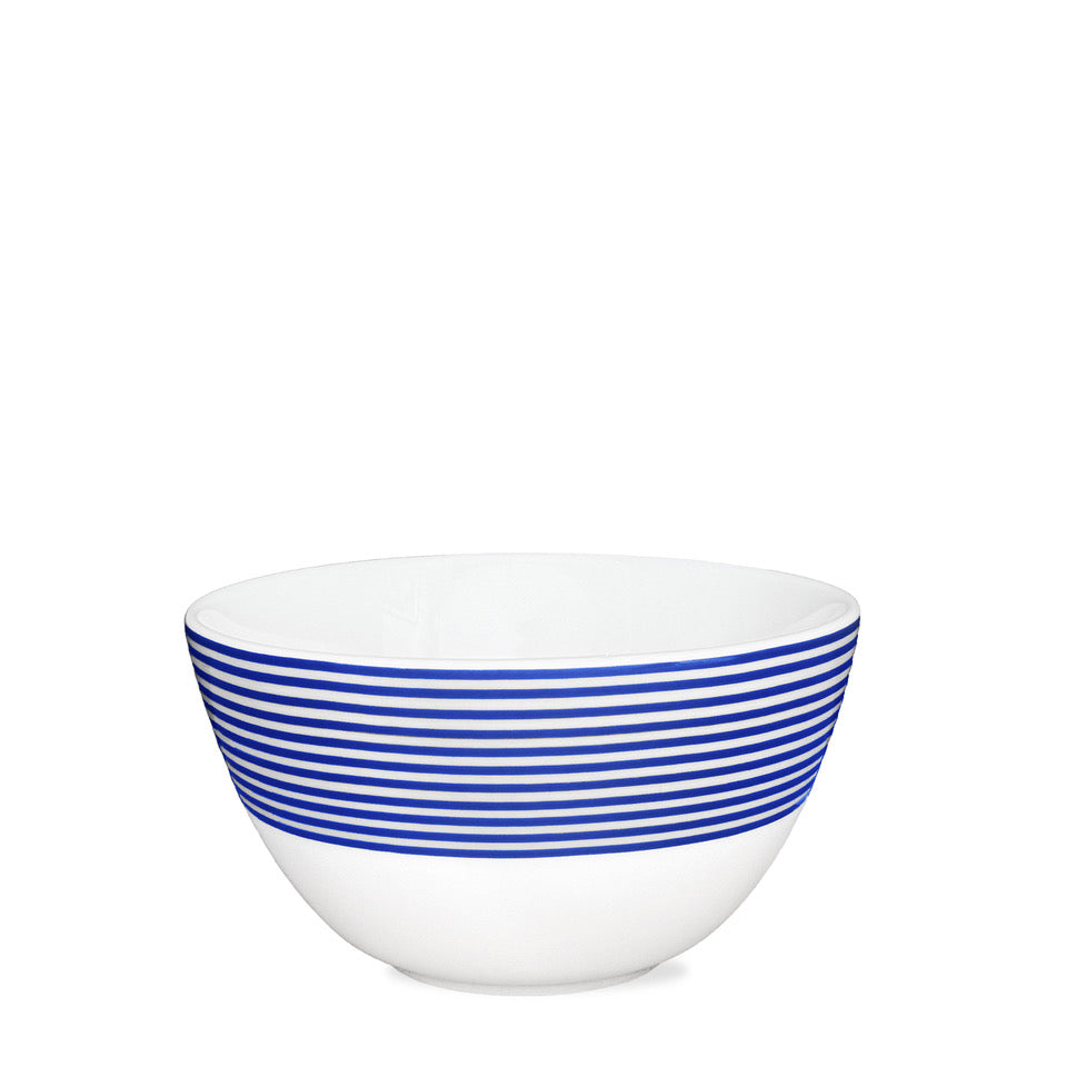 The Newport Stripe Cereal Bowl by Caskata Artisanal Home features premium white porcelain with multiple blue stripes near the rim, set against a classic white background.