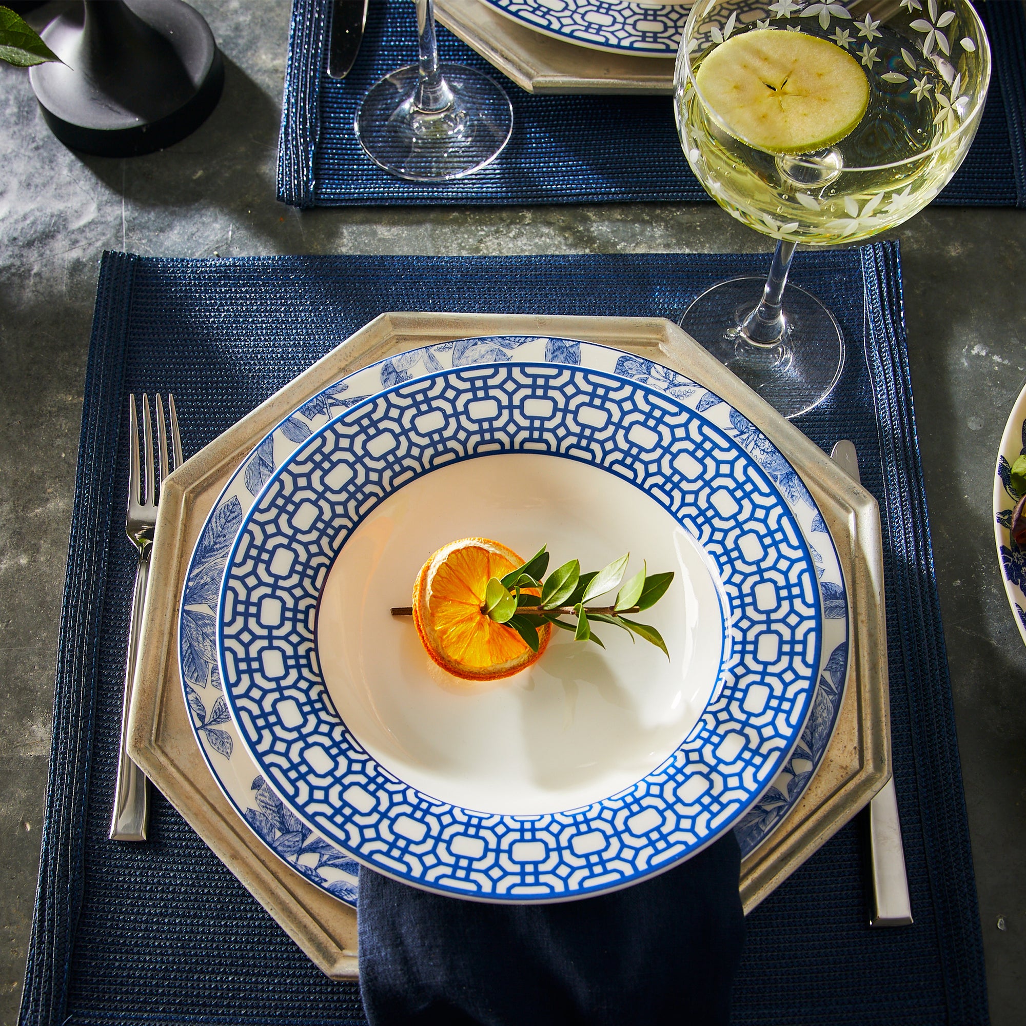 Newport Garden Gate Rimmed Soup Bowl in Blue and White Porcelain on an Arbor Blue Dinner plate from Caskata.