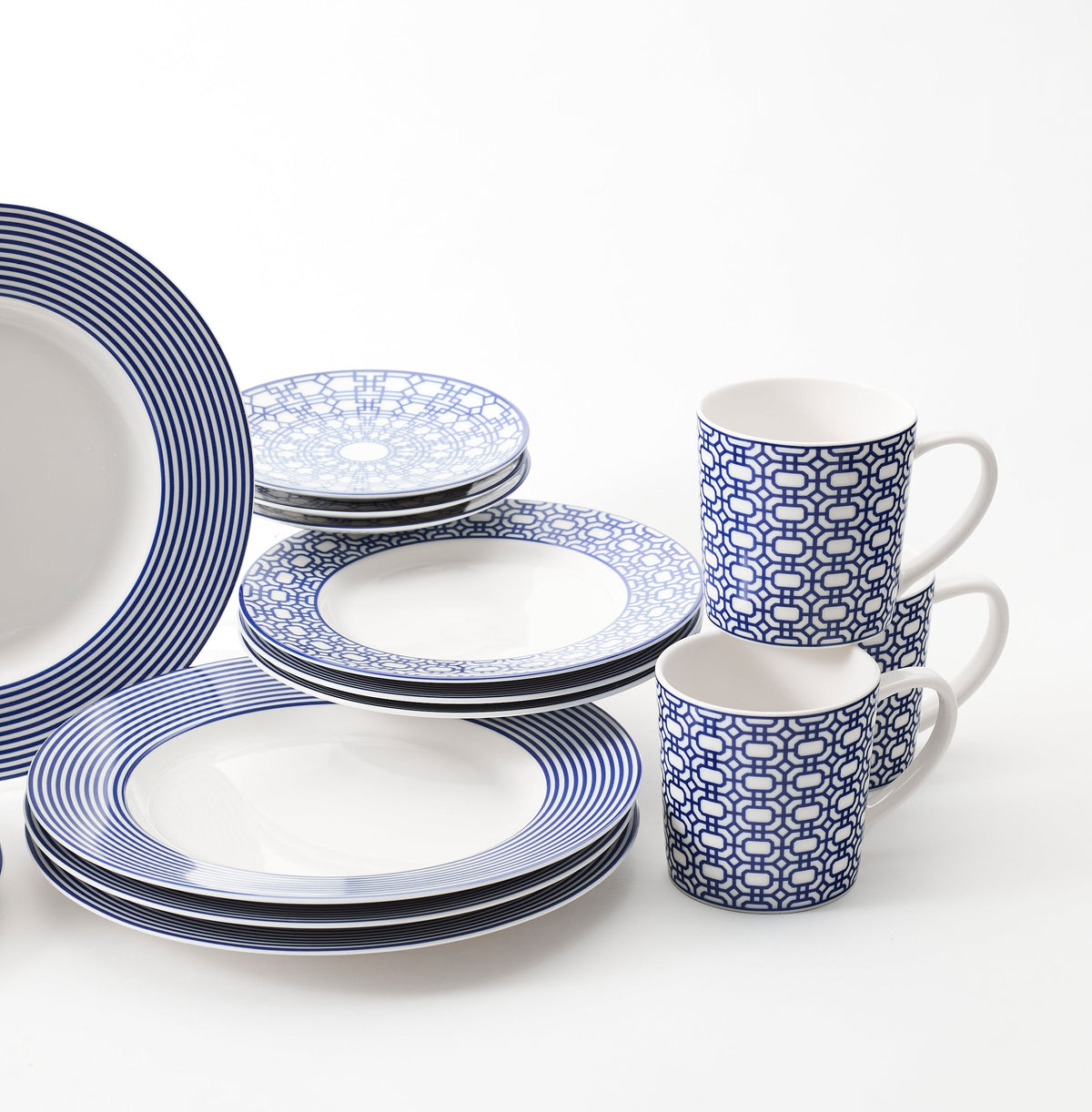 A set of Caskata porcelain dinnerware on a Newport Stripe Table for 4.