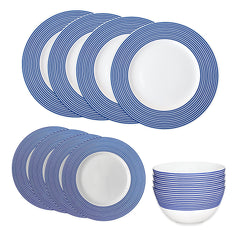 The Caskata Newport Stripe Table for 4 set includes porcelain plates and bowls with a white base and blue concentric stripes, adding casual elegance to your table.