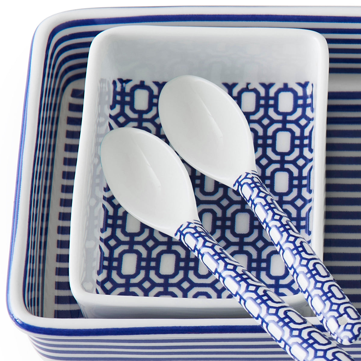 A square bowl with blue and white geometrics filled with Caskata&#39;s Newport Small Spoon Set of 6.