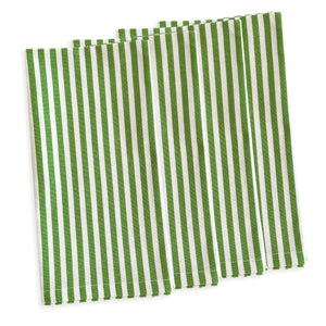 Four Caskata Pinstripe Dinner Napkins in spring green cotton with white vertical stripes are laid flat and slightly overlapping on a white background.