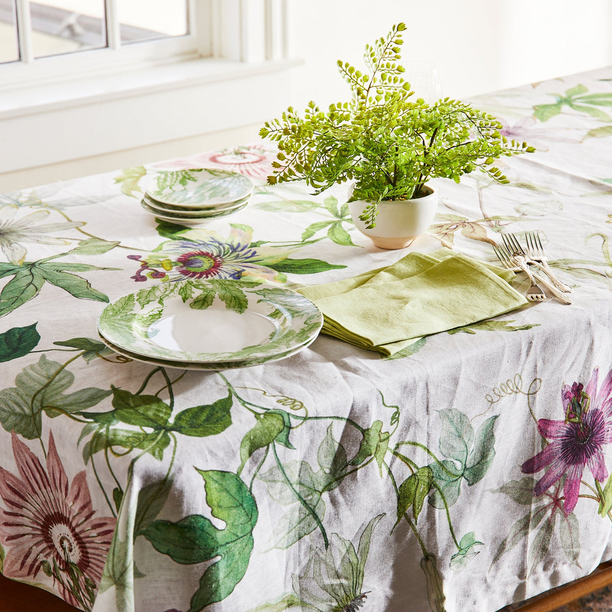 A Passionflower Linen Tablecloth adorned with passionflowers, by TTT.