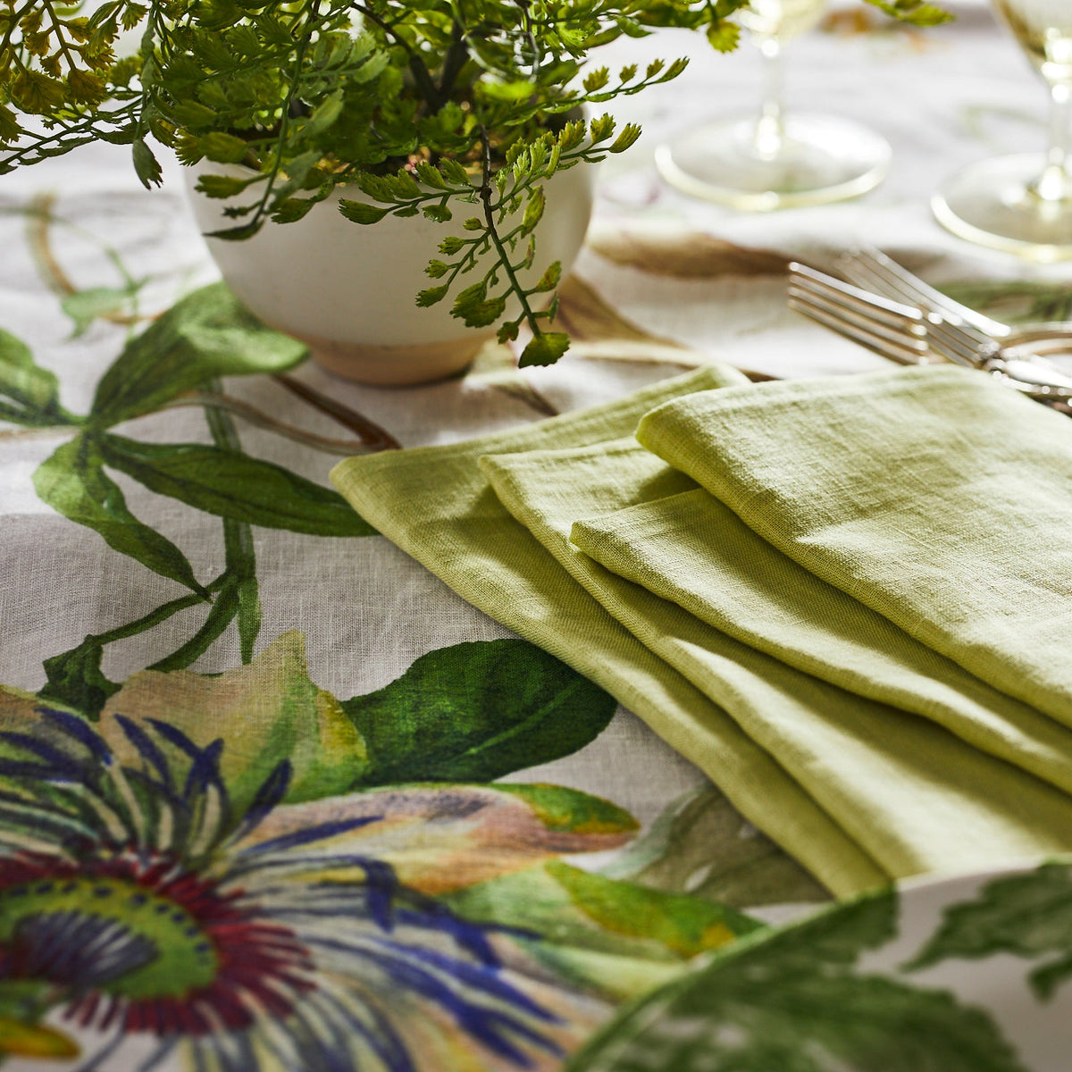 Closeup of floral detail on the Passionflower Linen Tablecloth from Caskata
