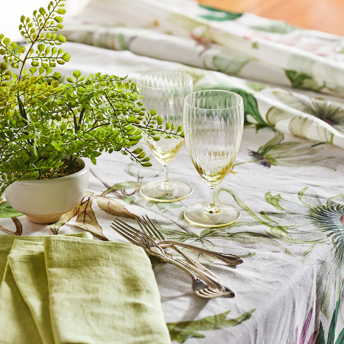 A Passionflower Linen Tablecloth with a plant on it by TTT.