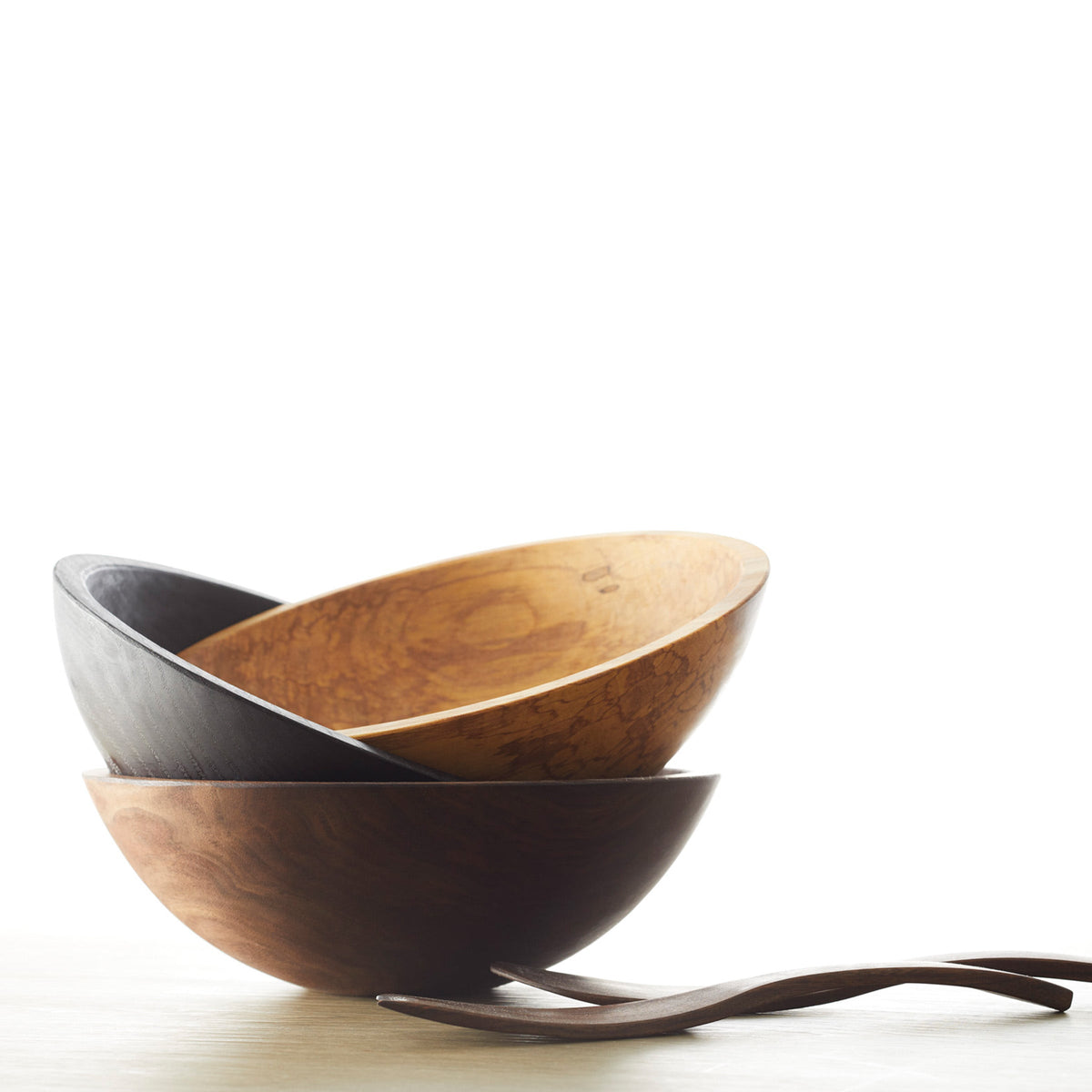 Three Peterman&#39;s Black Walnut 13&quot; Handcrafted Serving Bowls, crafted by an artisan woodworker, placed on a table.