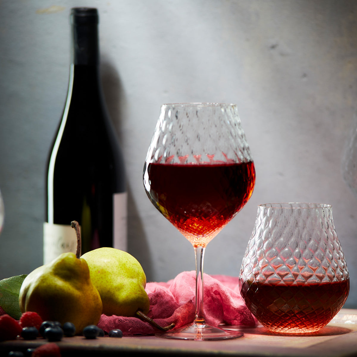 Phoebe clear stemless tulip crystal wine glasses from Caskata. still life, stemmed and stemless with red wine