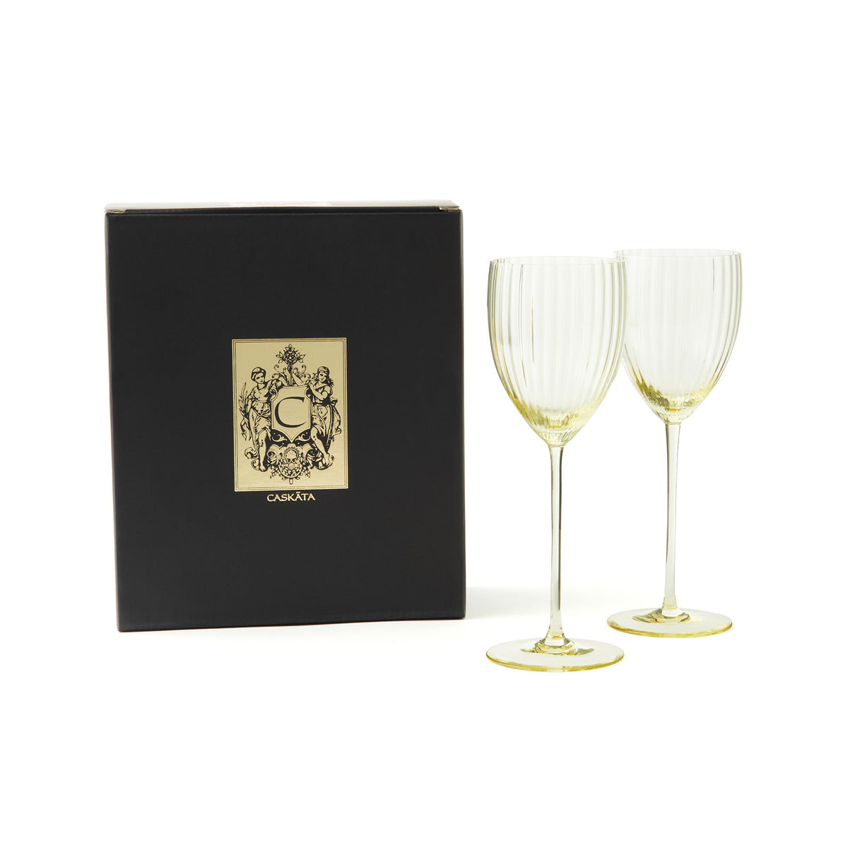 Quinn citrine yellow mouth-blown crystal white wine glasses from Caskata in a black and gold gift box.