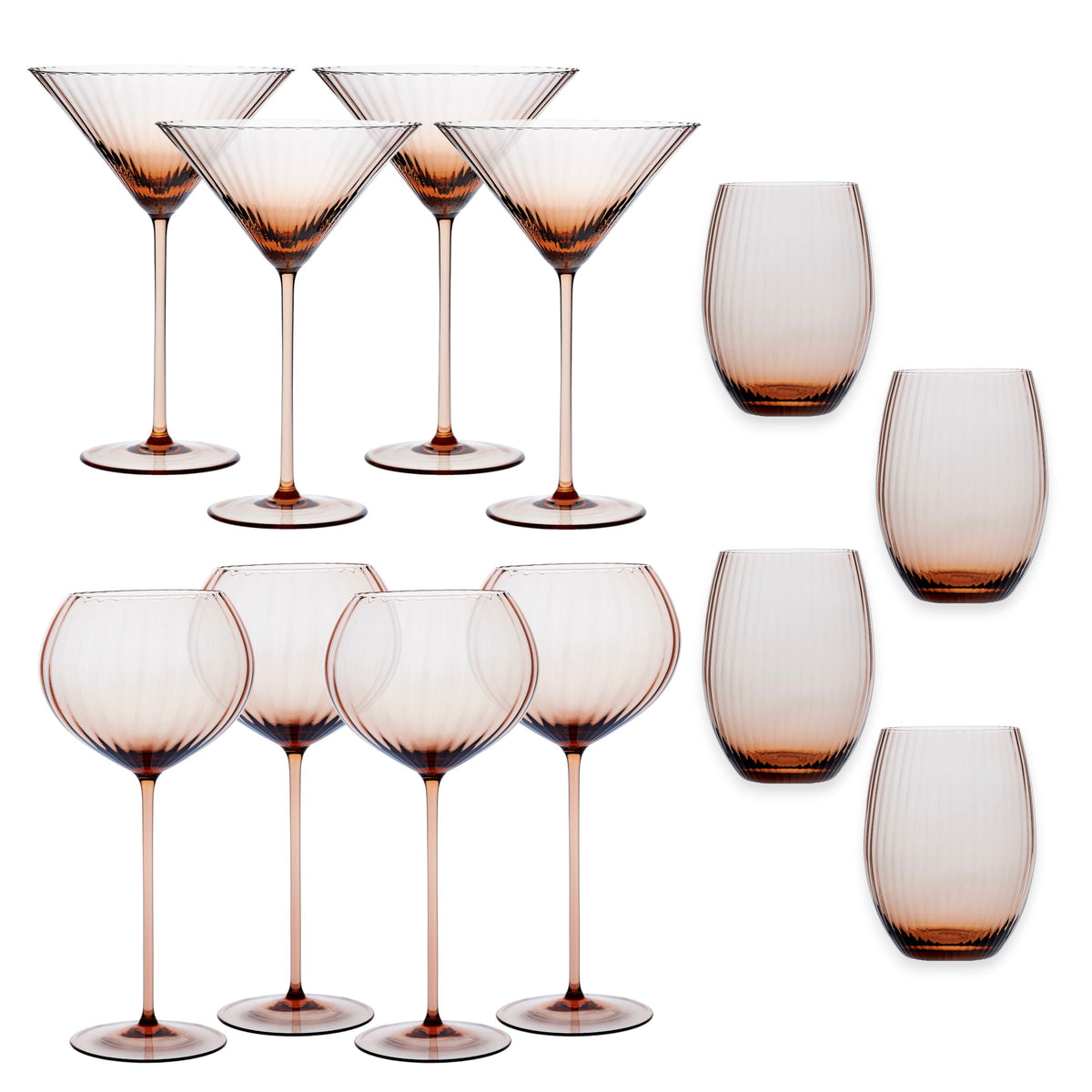 The Quinn Amber Cocktail Set by Caskata features twelve ribbed amber crystal glasses—four martini, four goblets, and four stemless—all mouth-blown and displayed on a white background.