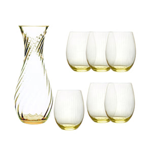 The Quinn Citrine Dinner Party Set by Caskata features a clear glass carafe with a swirl pattern and six matching stemless crystal glasses, all tinted a soft yellow—an elegant addition to any table.