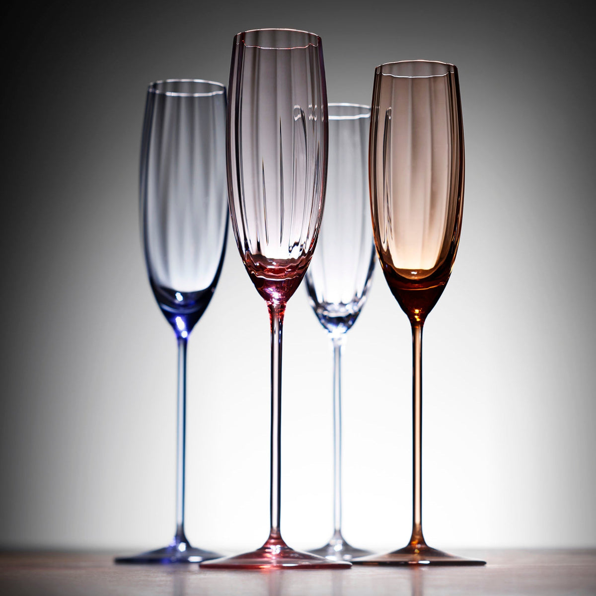 Caskata Quinn Optic Champagne Flutes in clear, blue, amber, rose