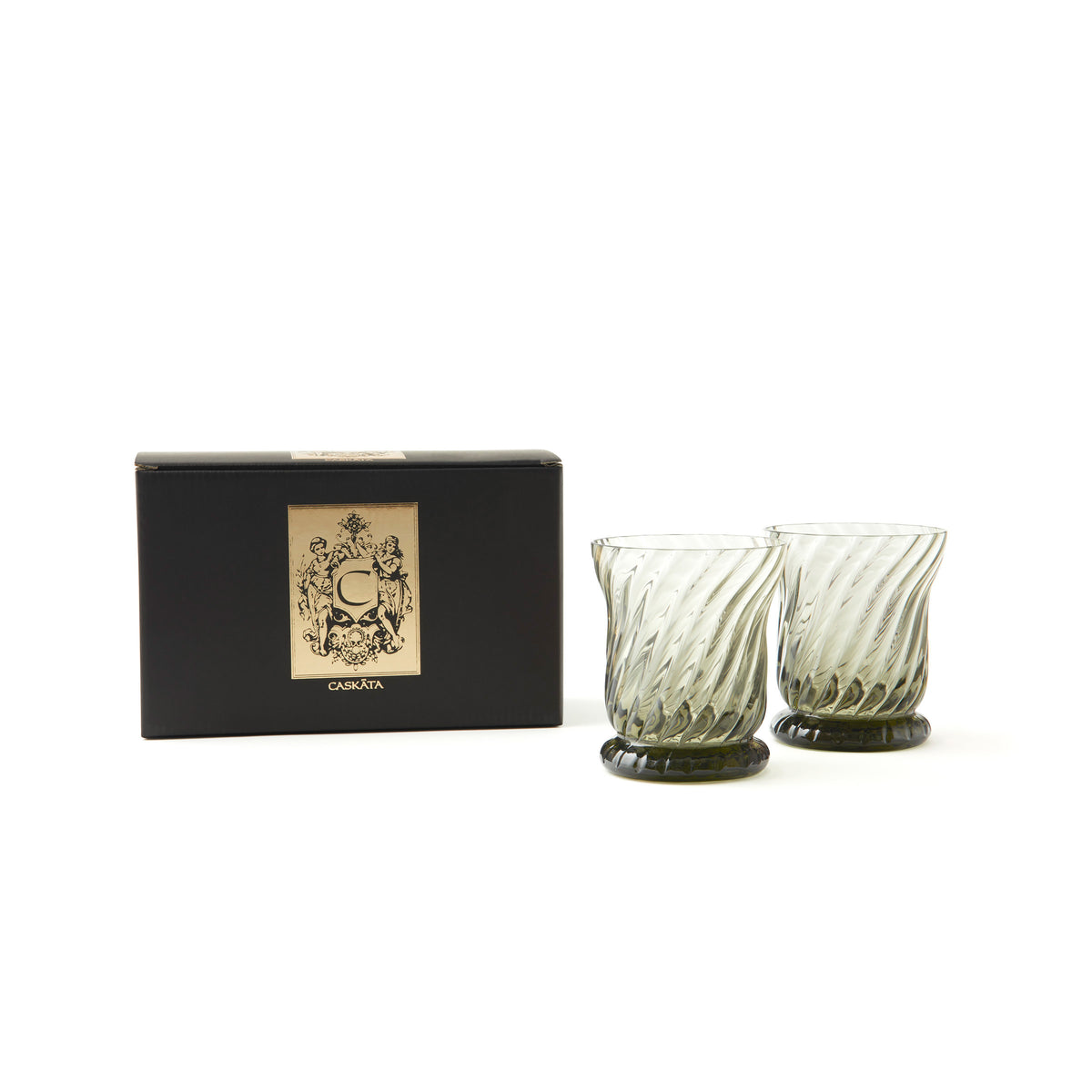 The Quinn Smoke Candlelight Bundle by Caskata includes two textured glass cups made from lead-free crystal displayed next to an elegantly designed black box.