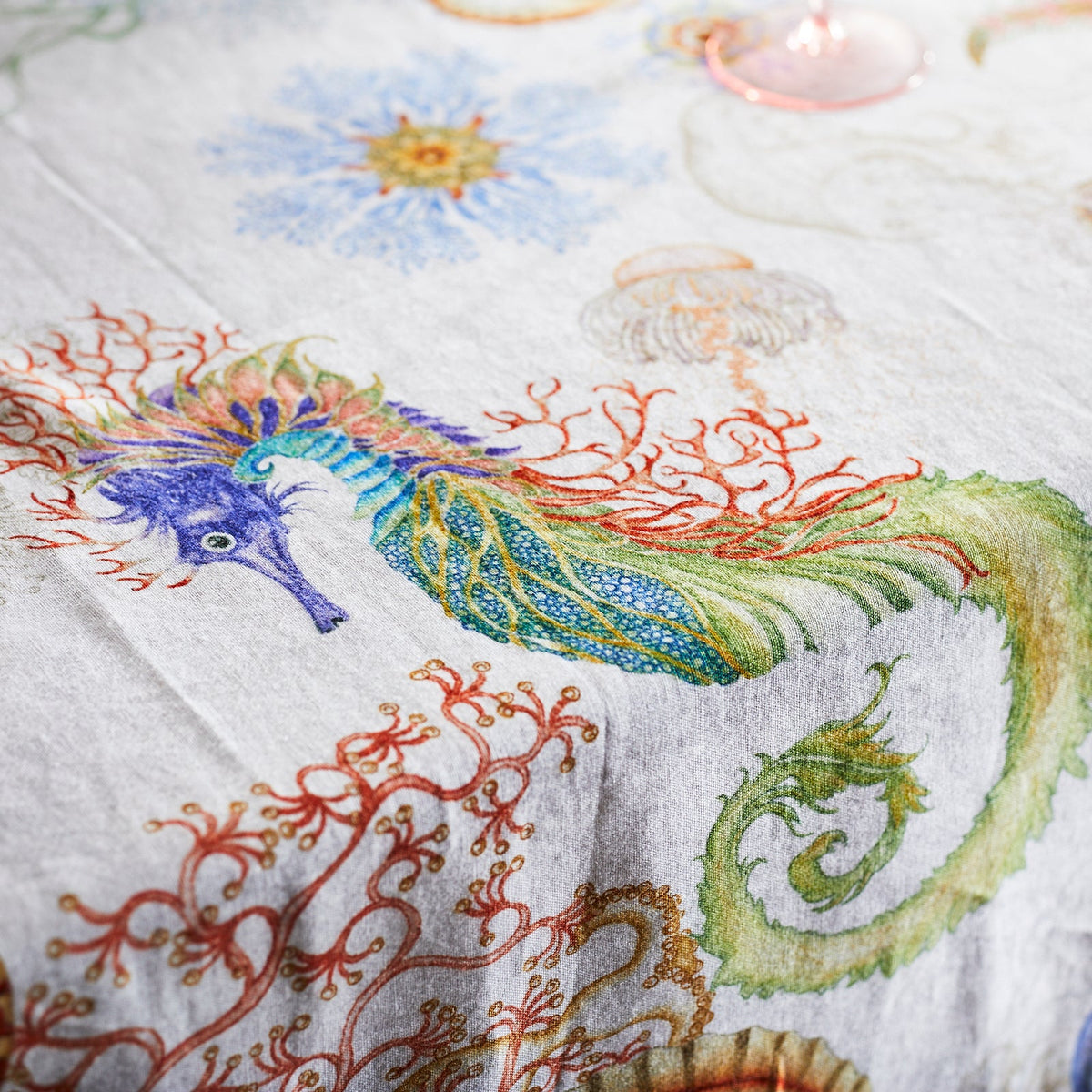 Seahorse Detail from the Reef Linen Tablecloth featuring watercolor Shells, Jellyfish, Coral, Seahorses from Caskata
