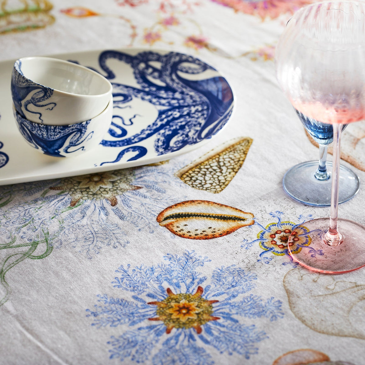 A blue and white Reef Hemp tablecloth with a vivid watercolor octopus on it. (Brand Name: TTT)