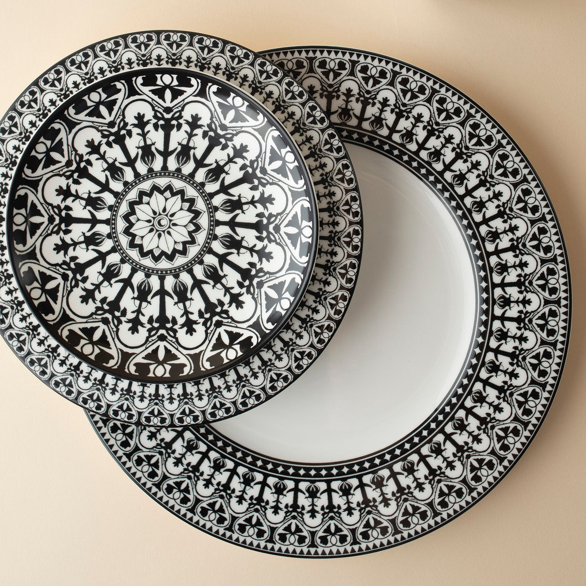 An ornate black and white dinnerware plate resembling a Casablanca design pattern, the Casablanca Salad Plate by Caskata Artisanal Home.