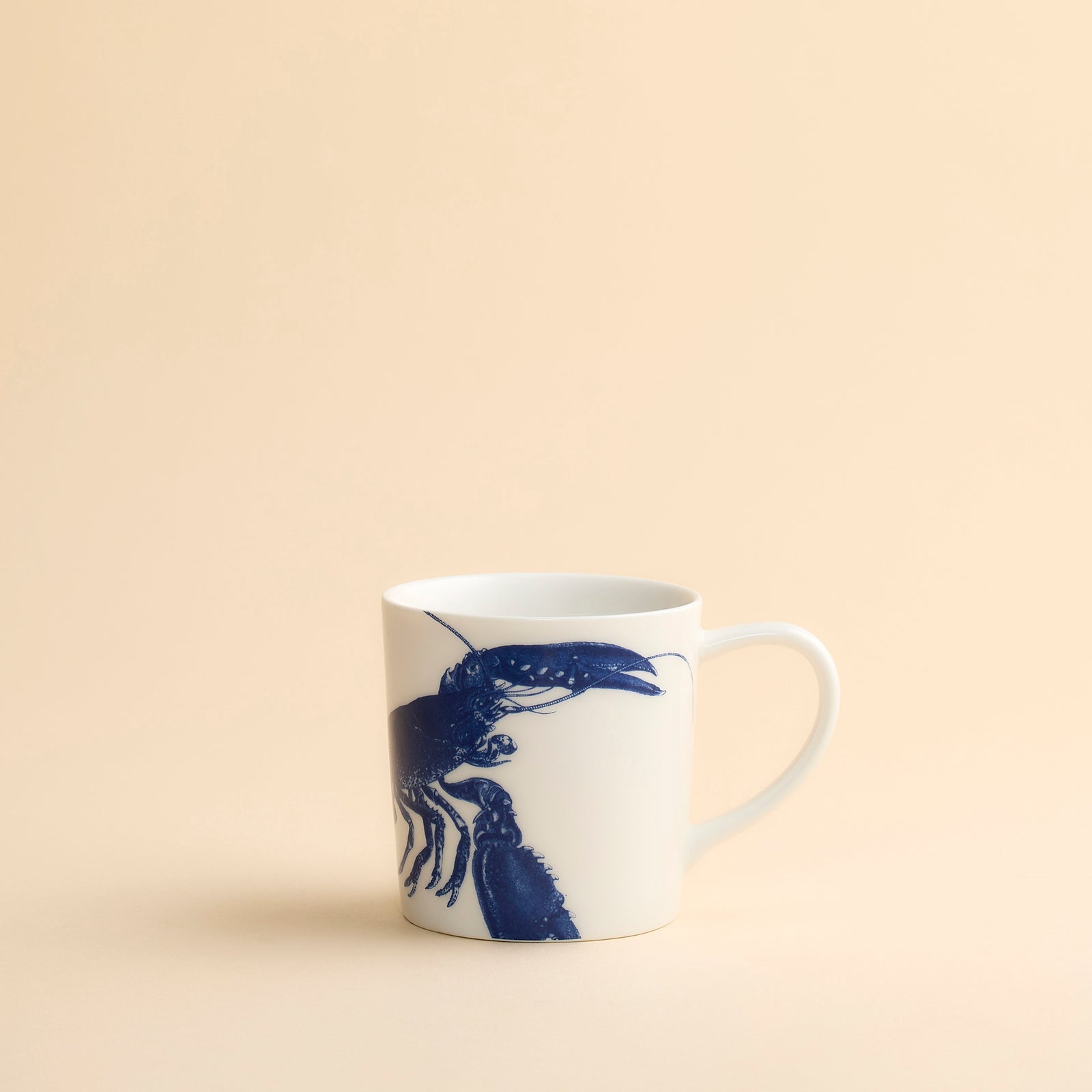 Classic and graphic this blue lobster wraps around this high-fired porcelain oversized mug from Caskata in their Blue Lobster pattern.
