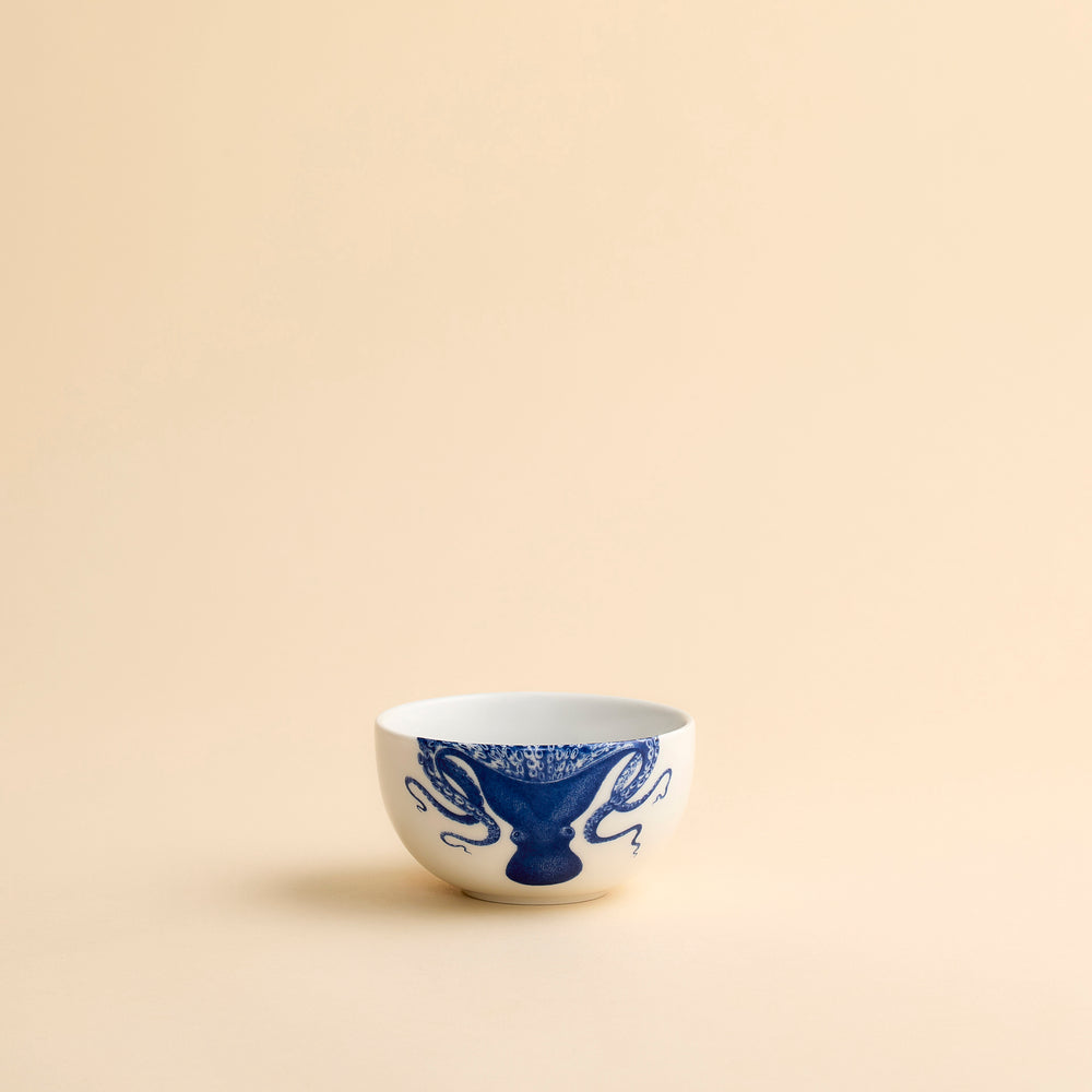 Lucy the playful octopus from Caskata wraps her arms around and over the rim of this snack bowl in creamy white porcelain.
