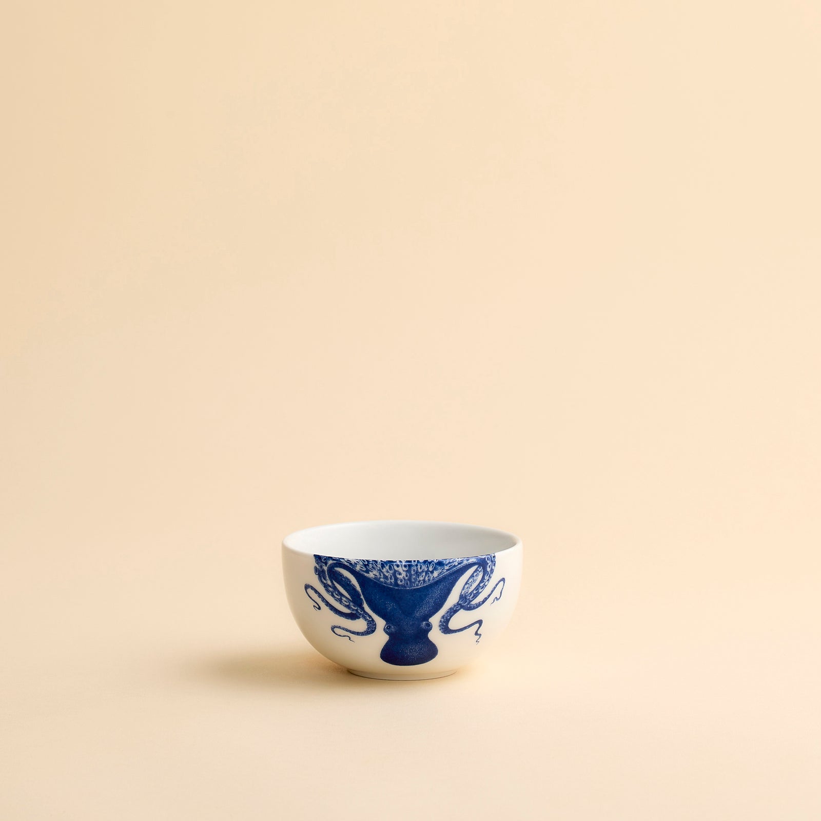 Lucy the playful octopus from Caskata wraps her arms around and over the rim of this snack bowl in creamy white porcelain.