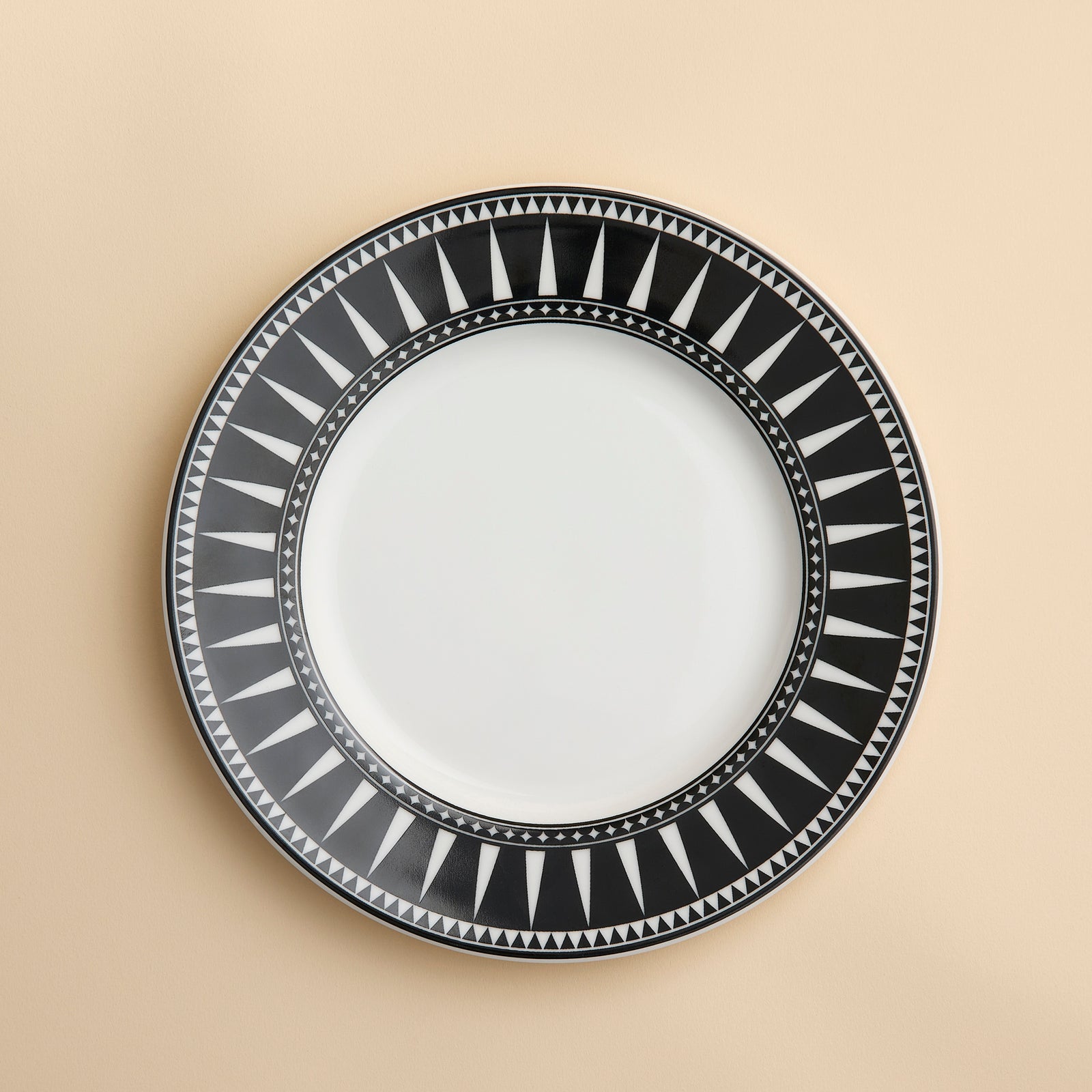 Marrakech pattern in bold geometric spikes around a rim of this porcelain salad plate from Caskata