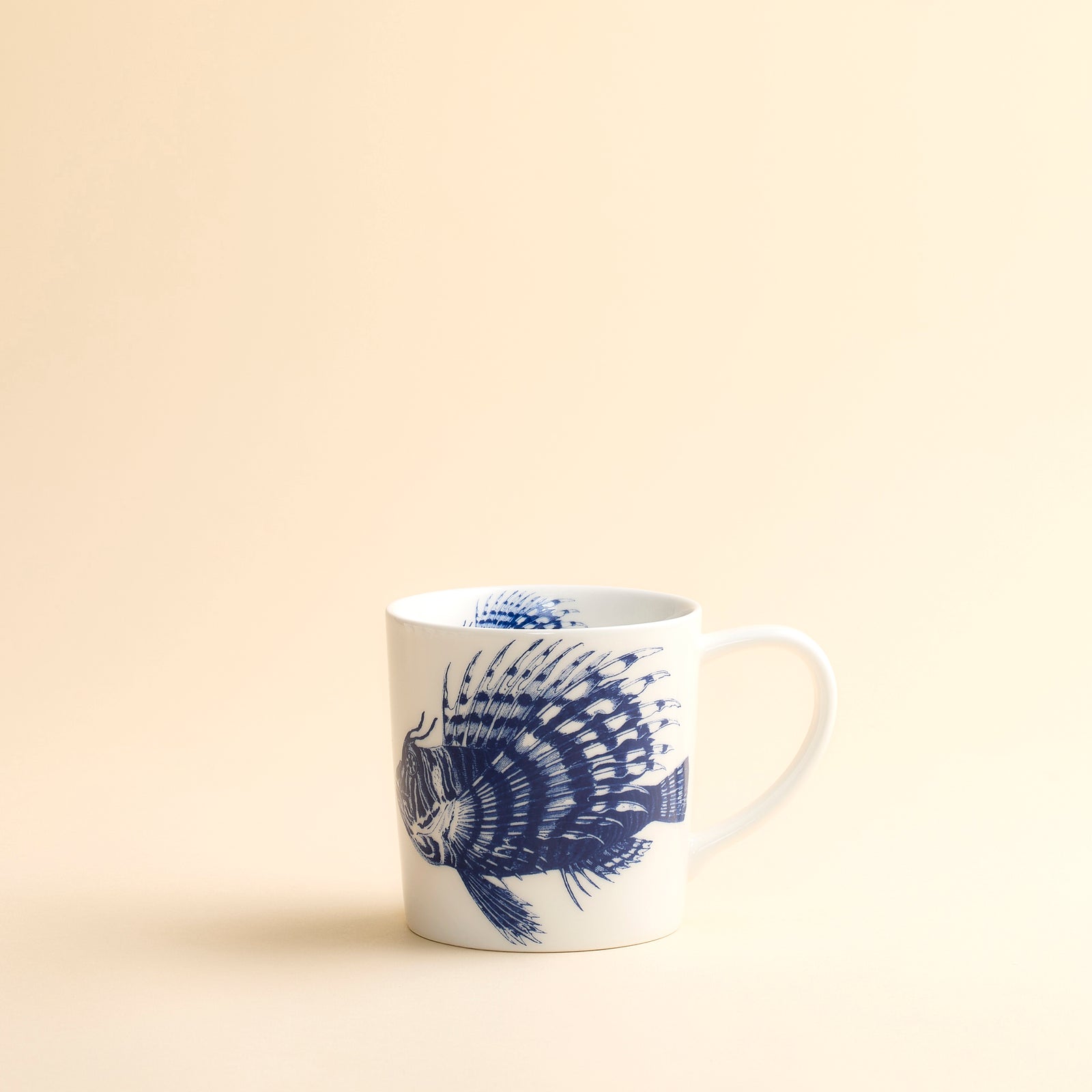 Our favorite Spiky Fish with an attitude adorns the inside and outside of this high-fired, dishwasher safe blue and white porcelain mug from Caskata