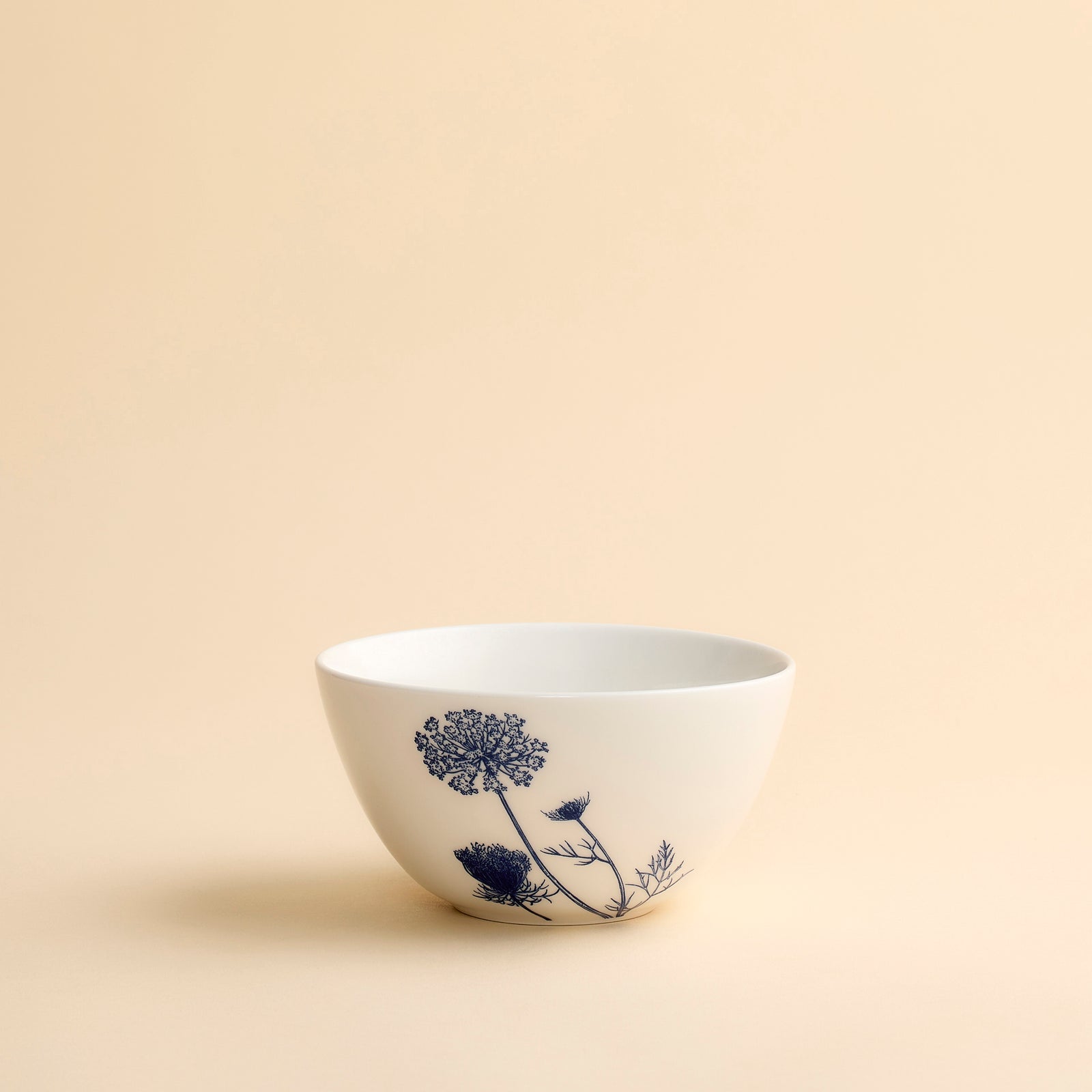 Cereal Bowl in Summer Blues porcelain bowl from Caskata in blue and white featuring a single Queen Anne's Lace bloom.
