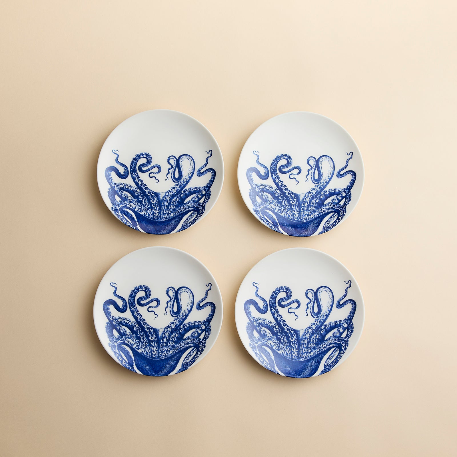 Lucy the Octopus is playfully splashing across this set of 4 small appetizer plates in high-fired porcelain from Caskata