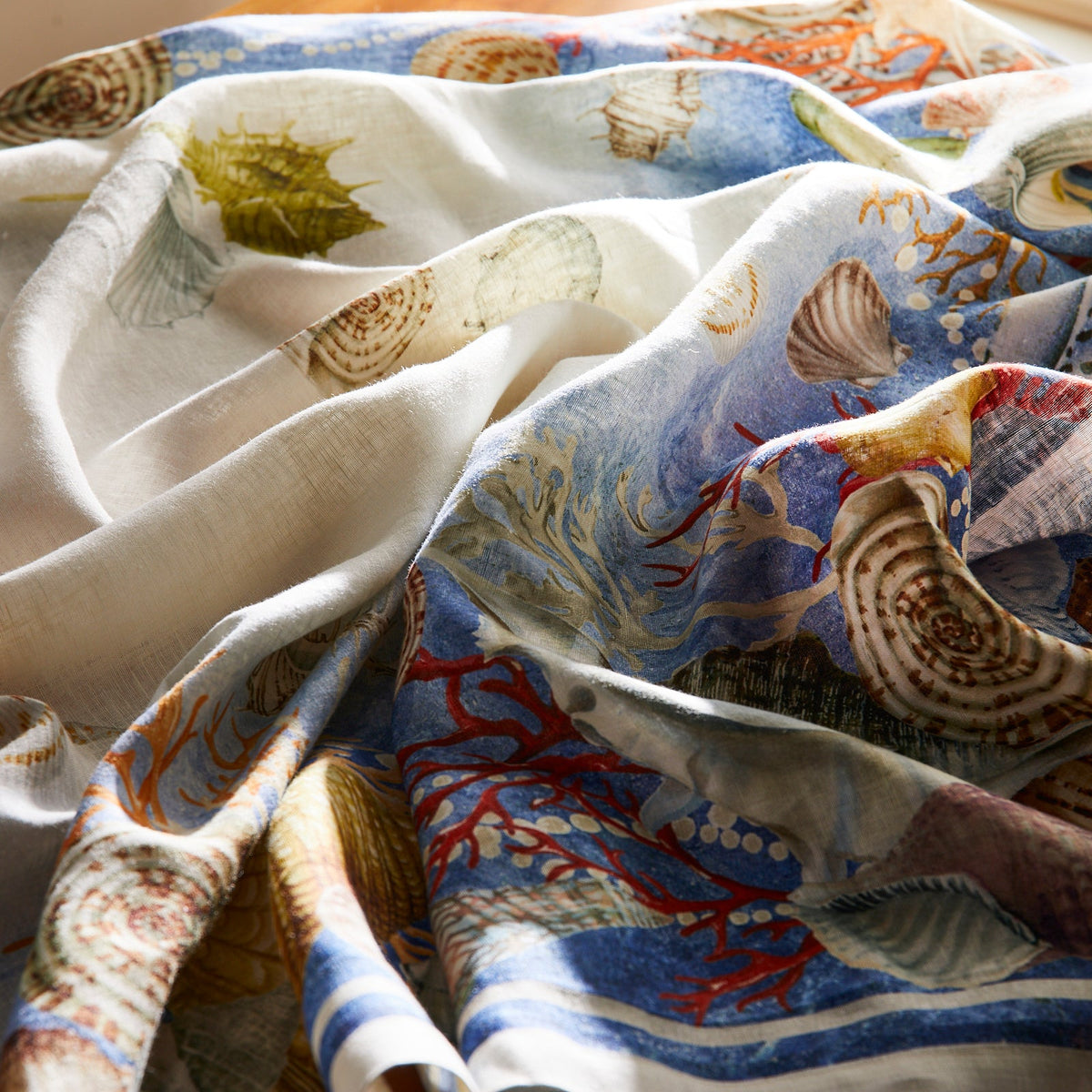 Closeup of Sanibel Linen Tablecloth with watercolor Shells and Coral from Caskata