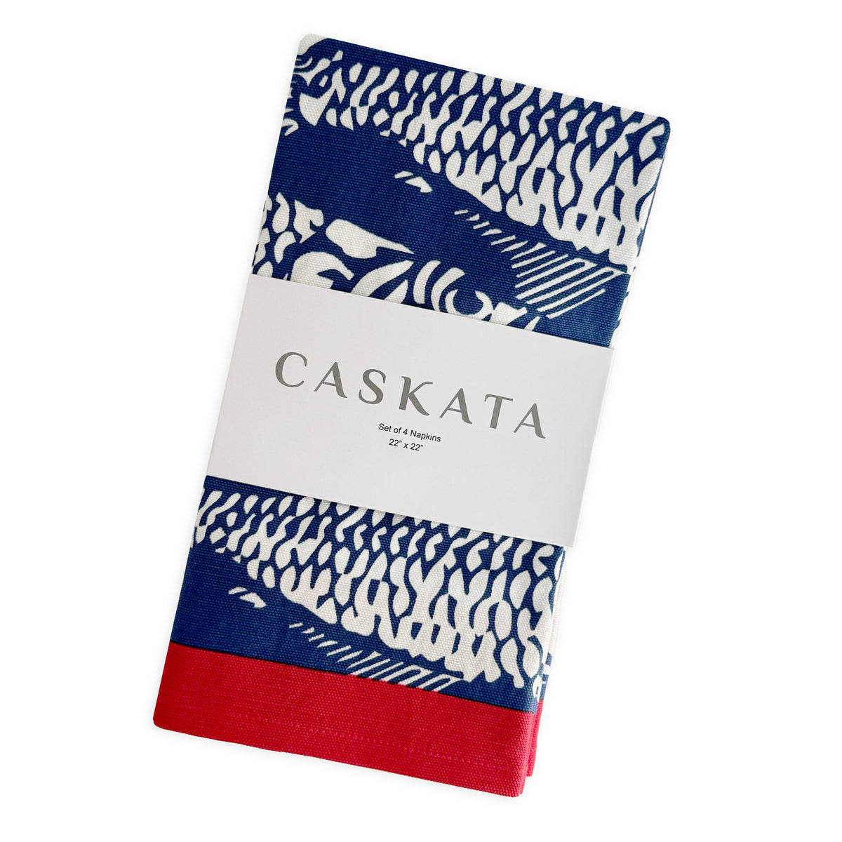 The Caskata Sardines Dinner Napkins, Set of 4, feature a blue, white, and red fish scale pattern on folded cotton napkins, each measuring 22" x 22".
