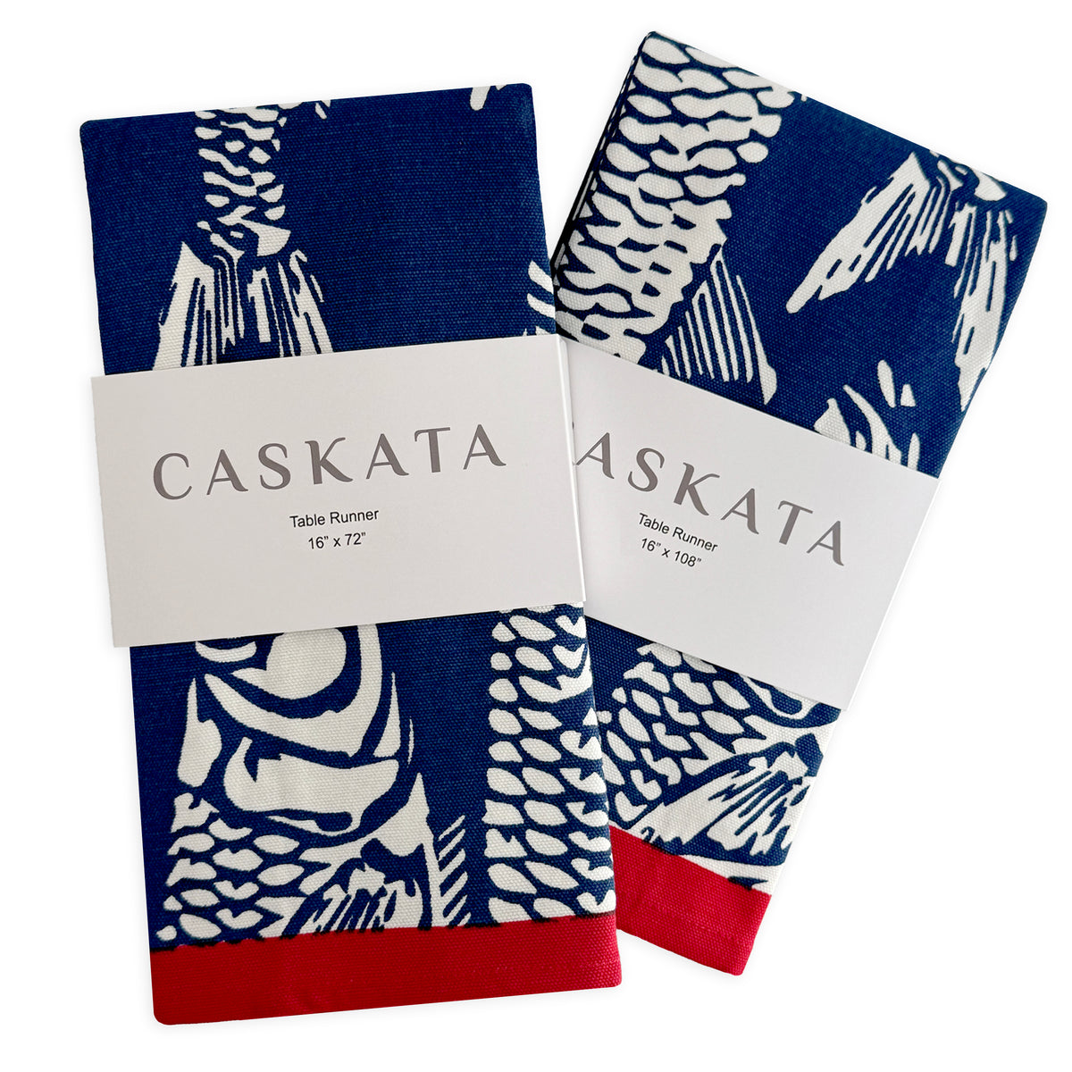 Two folded Caskata Sardines Table Runners, each with blue, white, and red fish designs, labeled 16" x 72" and 16" x 108".