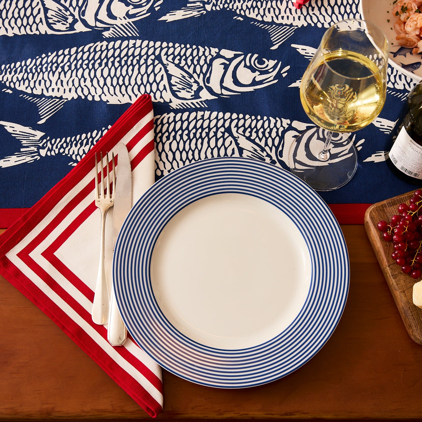 Set of four Caskata Triple Stripe Red Dinner Napkins, made from machine-washable cotton and featuring three red stripes, add a classic touch to your table.