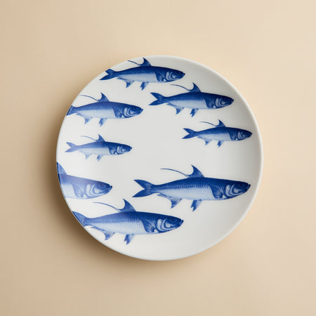 Caskata School of Fish Coupe Salad Plate decorated with a pattern of blue fish.