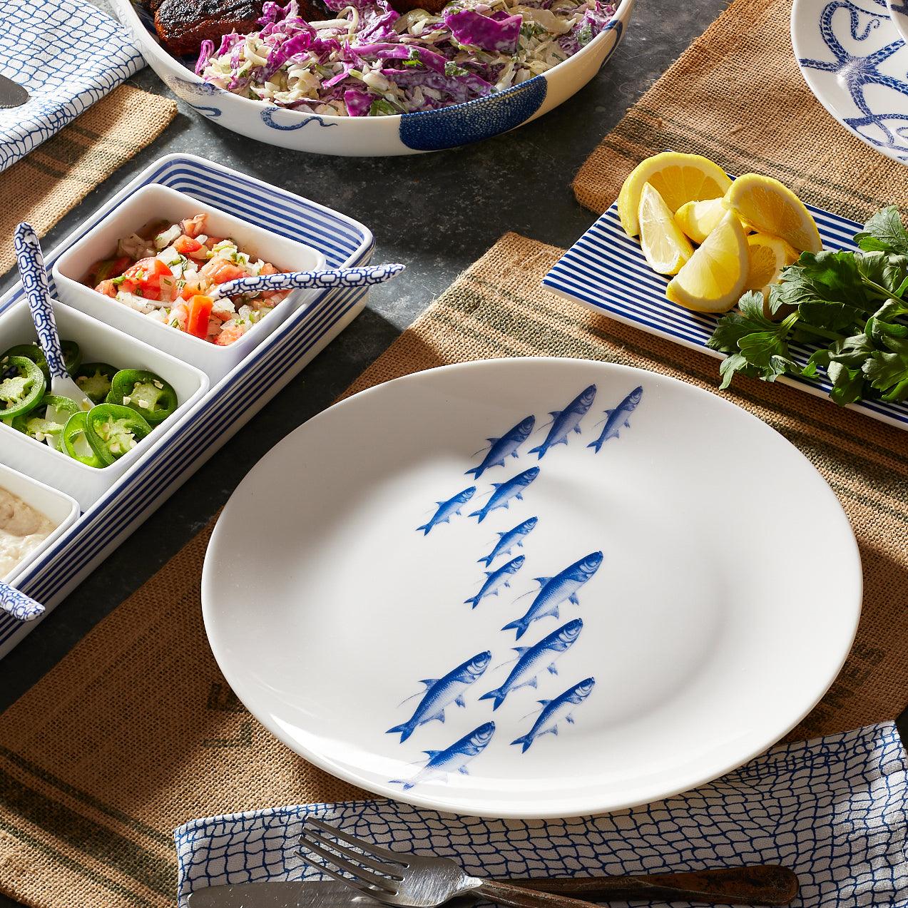 A brilliant blue School of Fish swims across this porcelain coupe dinner plate from Caskata.