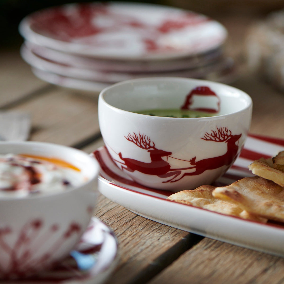 A festive Sleigh Snack Bowl from Caskata Artisanal Home on a table, evoking holiday spirits.