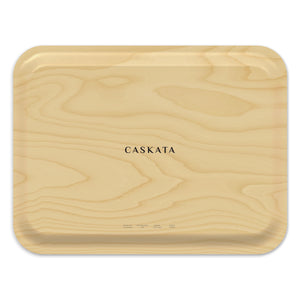 The Spotted Stingray Large Rectangular Birchwood Tray by Caskata, part of the Coastal Collection, features a subtle wood grain design with rounded corners and the brand name printed in the center, combining elegance with eco-friendly craftsmanship.