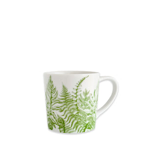 The Caskata Spring Verde Mug is a white porcelain coffee mug with a handle, featuring a green fern leaf design on the side.