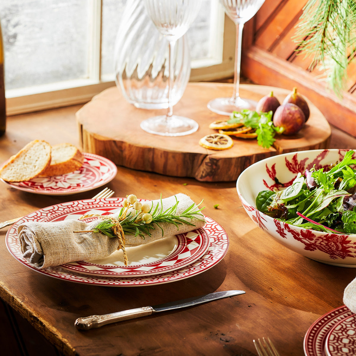 A premium Newport Garden Gate Crimson Dinner Plate porcelain dinnerware table with plates and food on it, dishwasher and microwave safe from Caskata Artisanal Home.